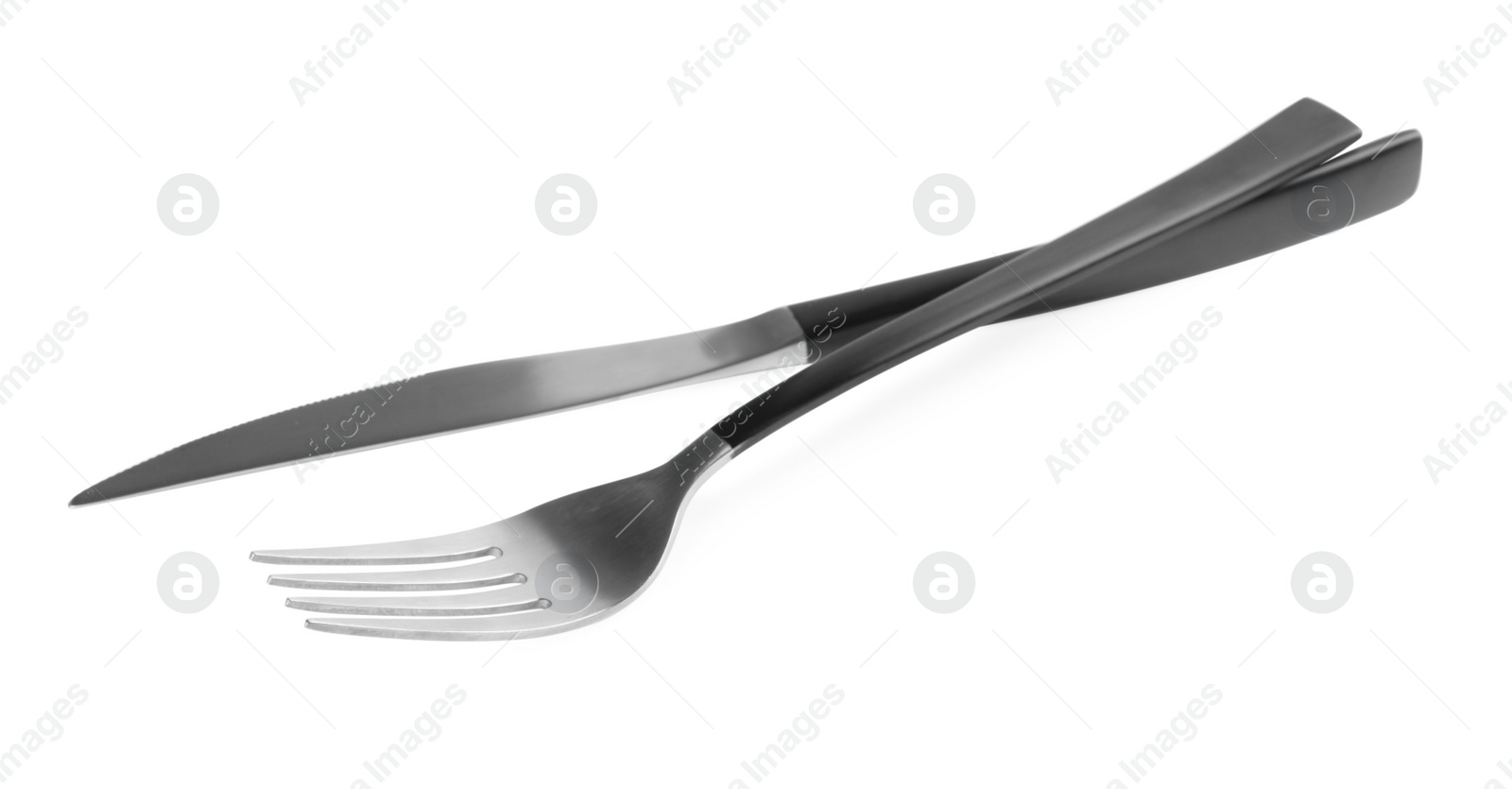 Photo of New fork and knife with black handles on white background