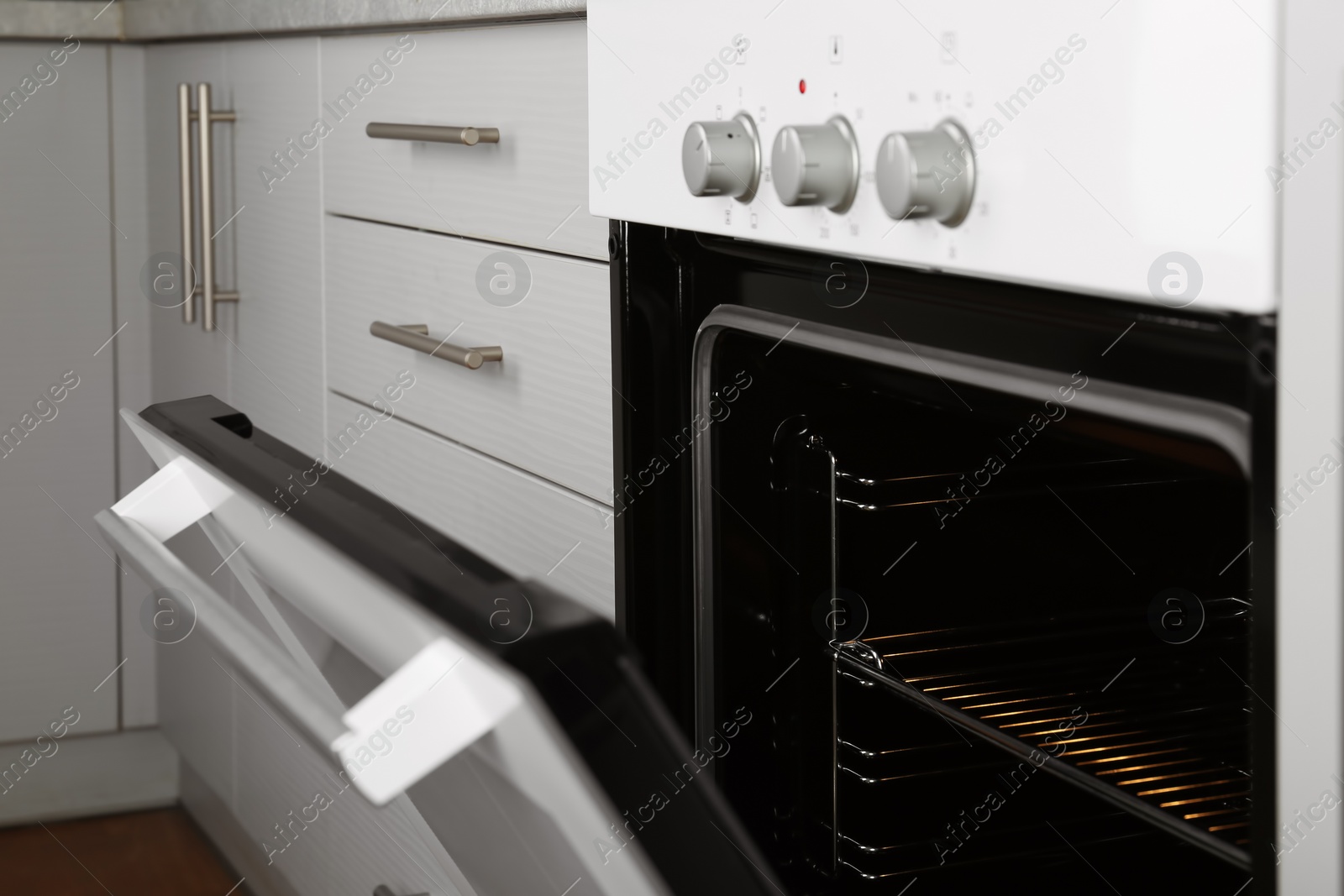 Photo of Open empty electric oven in kitchen, closeup