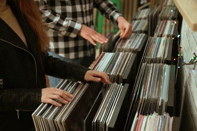 People choosing vinyl records in store, closeup