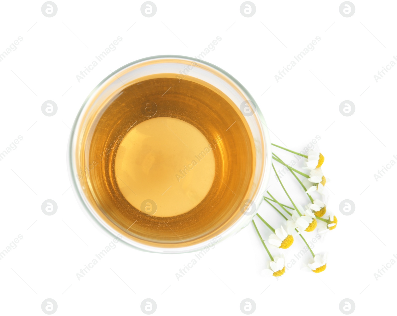 Photo of Delicious chamomile tea in glass isolated on white, top view