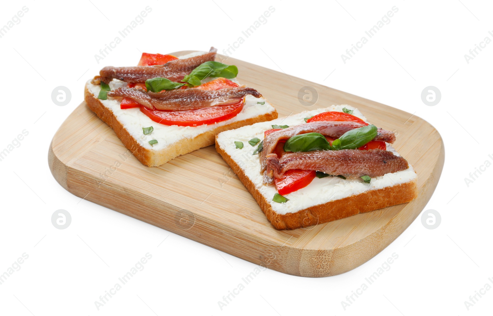 Photo of Delicious sandwiches with cream cheese, anchovies, tomatoes and basil on white background