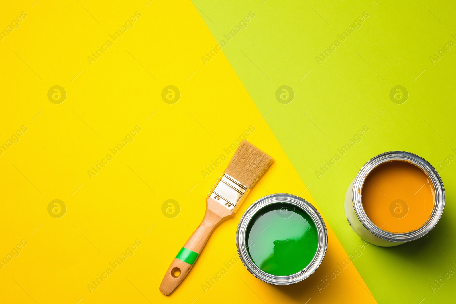 Photo of Flat lay composition with paint cans and space for text on color background