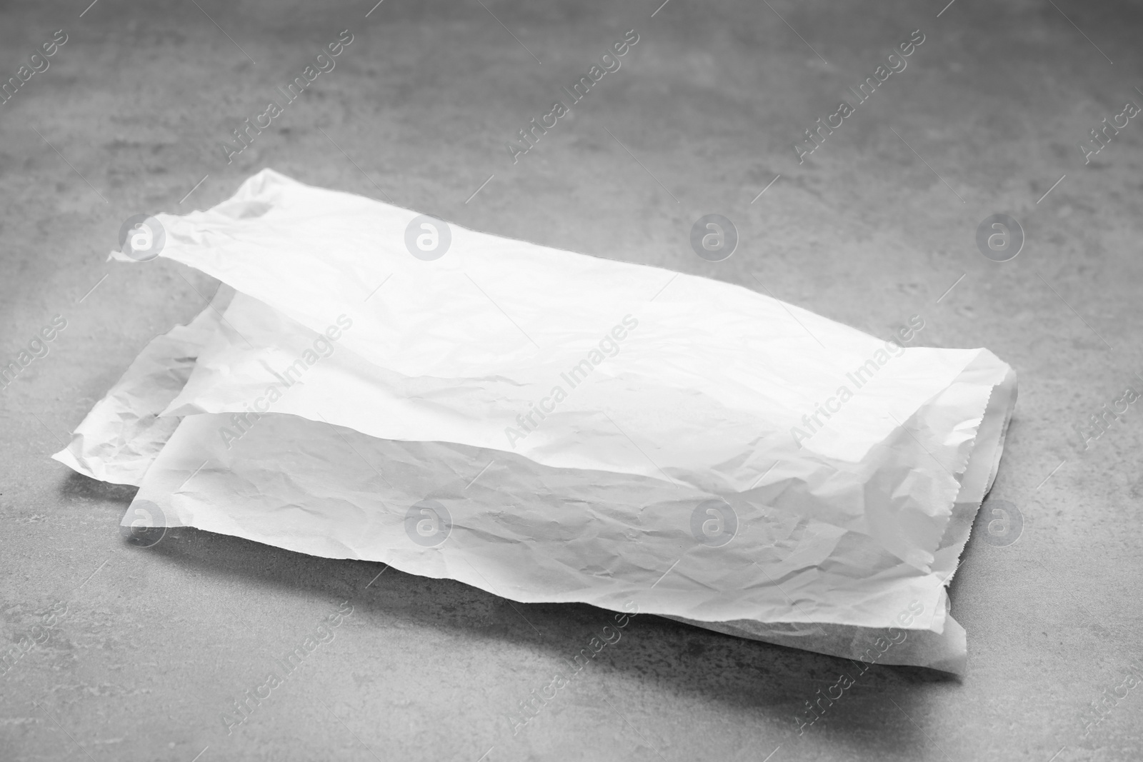 Photo of Sheets of baking paper on grey table