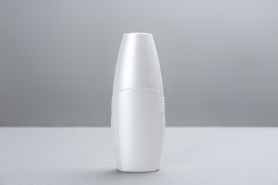 Bottle with insect repellent spray on grey background