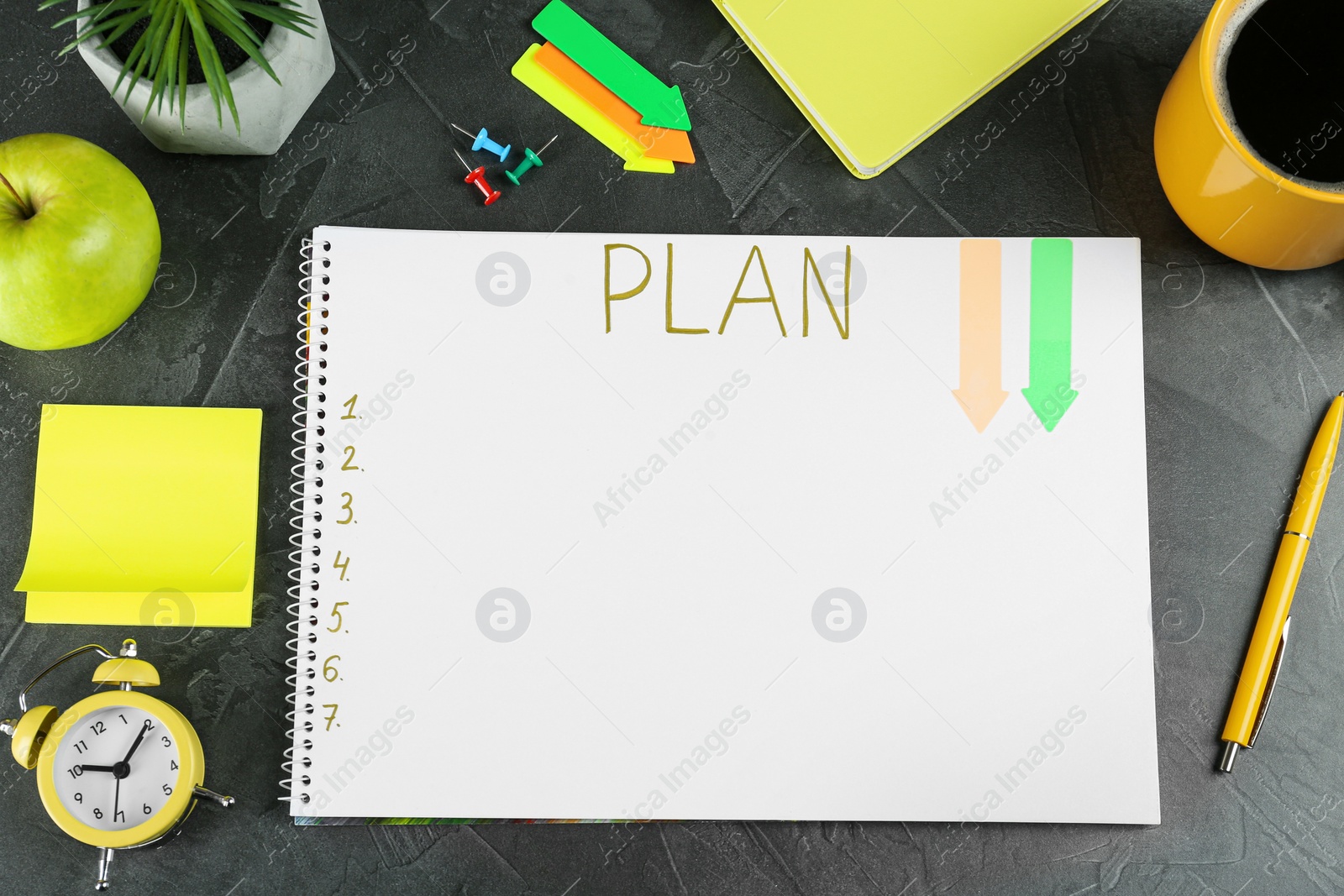 Photo of Flat lay composition of notebook with plan list on grey table