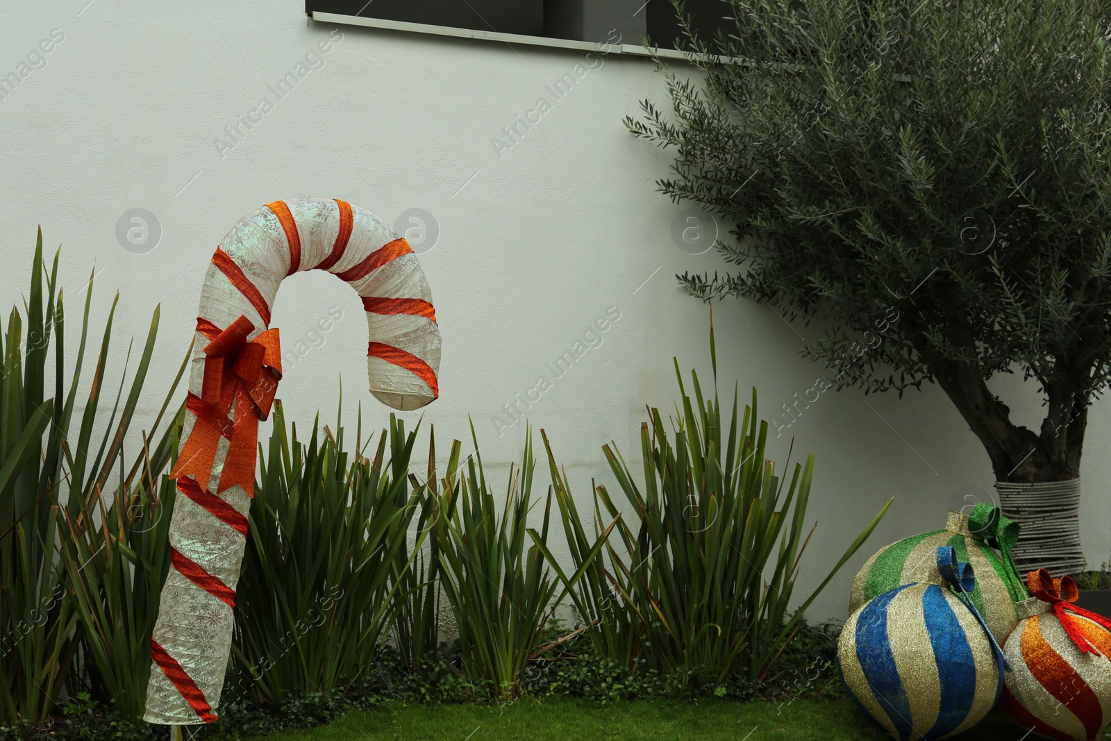 Photo of Beautiful Christmas street decorations on green grass outdoors