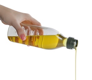 Woman pouring cooking oil from bottle on white background, closeup