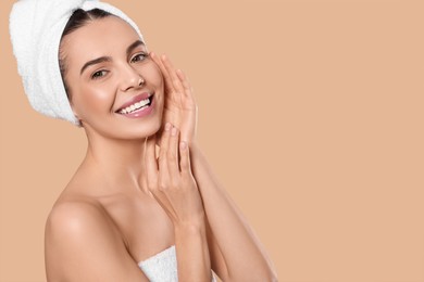 Photo of Young woman in towels on beige background, space for text. Spa treatment