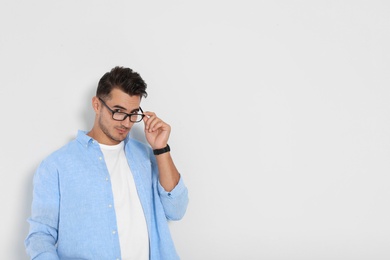 Portrait of handsome young man and space for text on white background