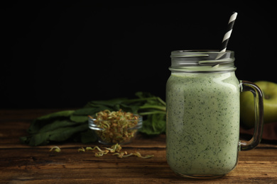 Photo of Tasty green buckwheat smoothie on wooden table