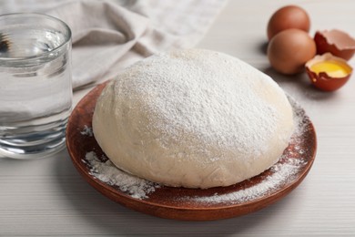 Photo of Dough and ingredients on white wooden table, closeup. Sodawater bread recipe