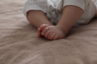 Photo of Little baby on brown blanket, closeup view