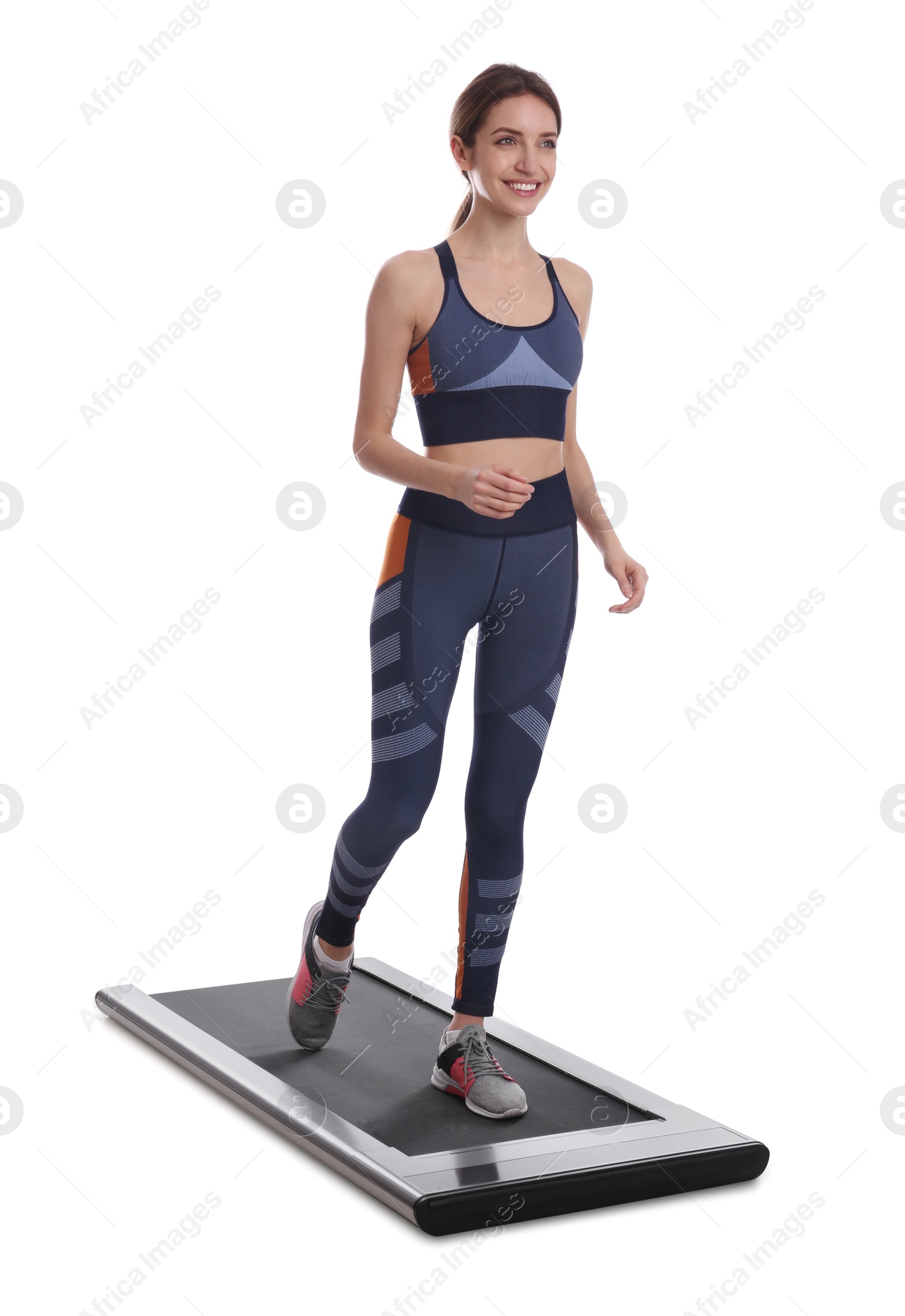 Photo of Sporty woman using walking treadmill on white background