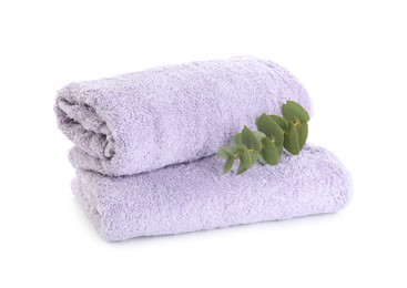 Photo of Violet terry towels and eucalyptus branch isolated on white