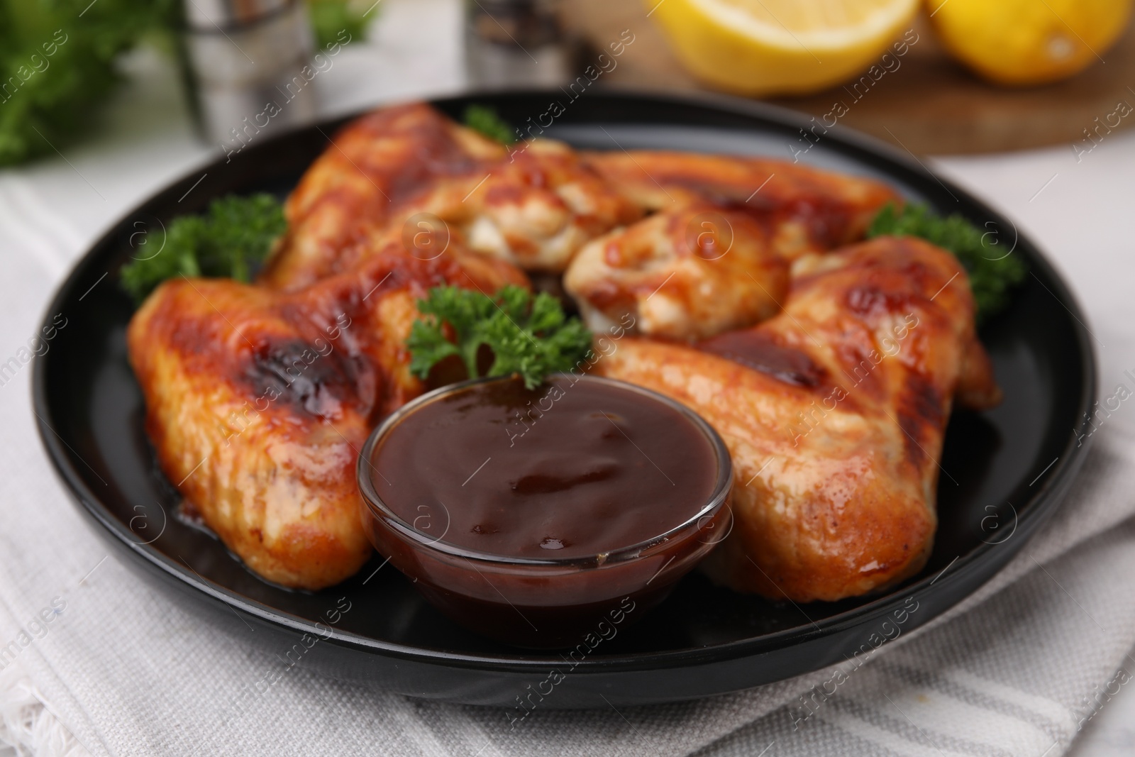 Photo of Fresh marinade and chicken wings on table, closeup