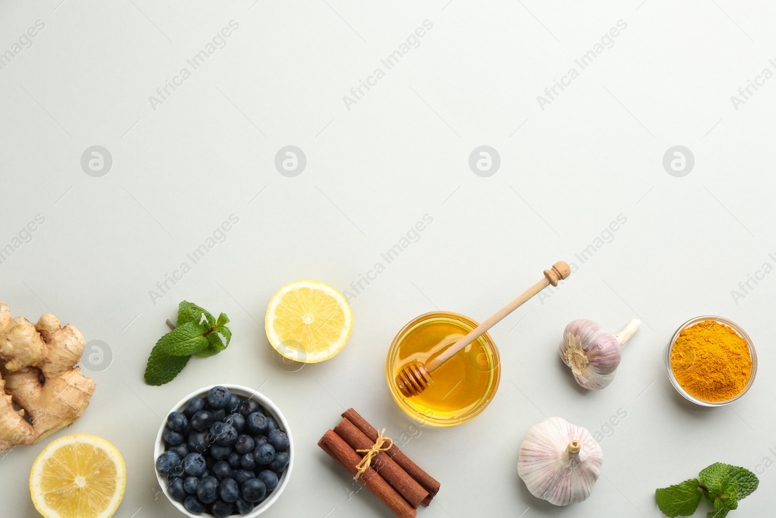 Photo of Flat lay composition with fresh products on grey background, space for text. Natural antibiotics