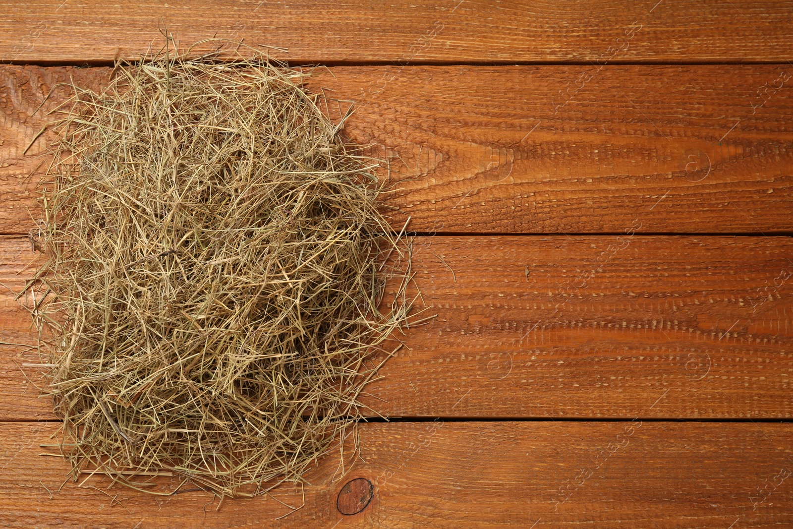 Photo of Dried hay on wooden background, top view. Space for text