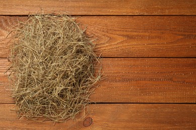 Photo of Dried hay on wooden background, top view. Space for text