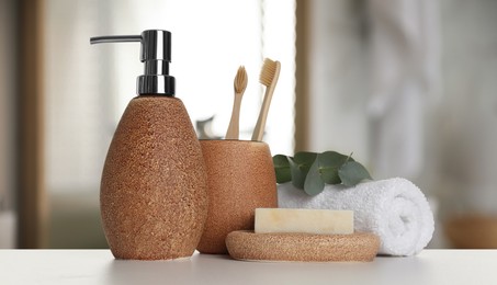 Bath accessories. Different personal care products and eucalyptus leaves on white table in bathroom, banner design