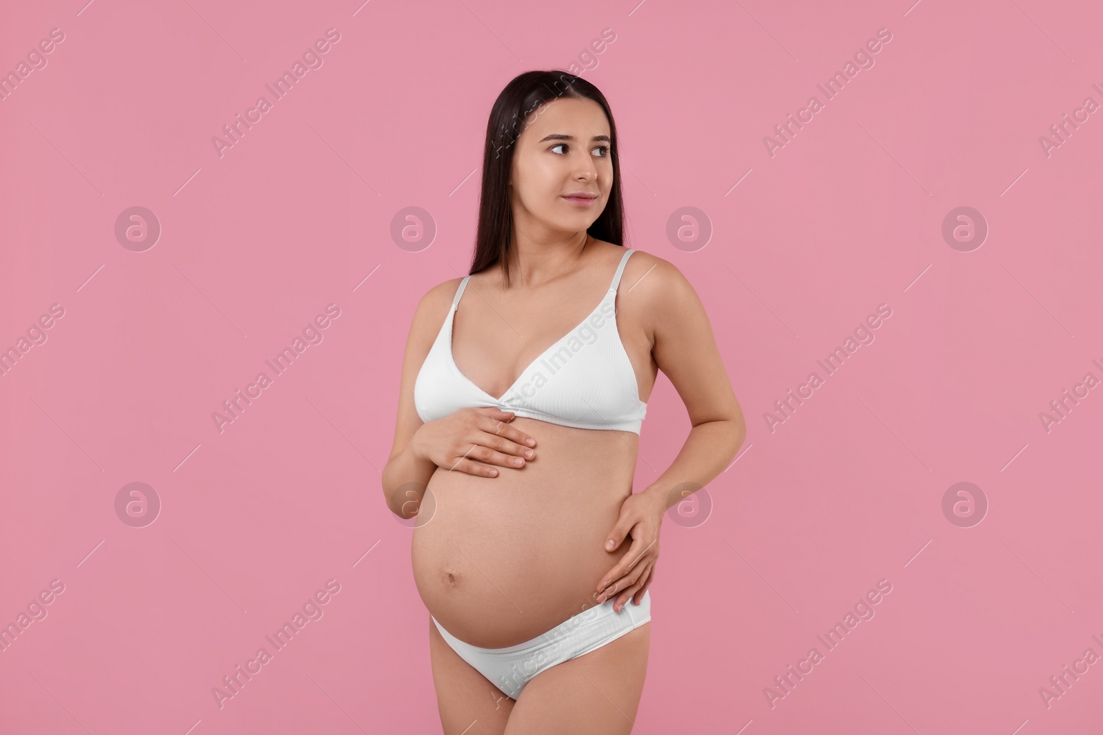 Photo of Beautiful pregnant woman in stylish comfortable underwear on pink background