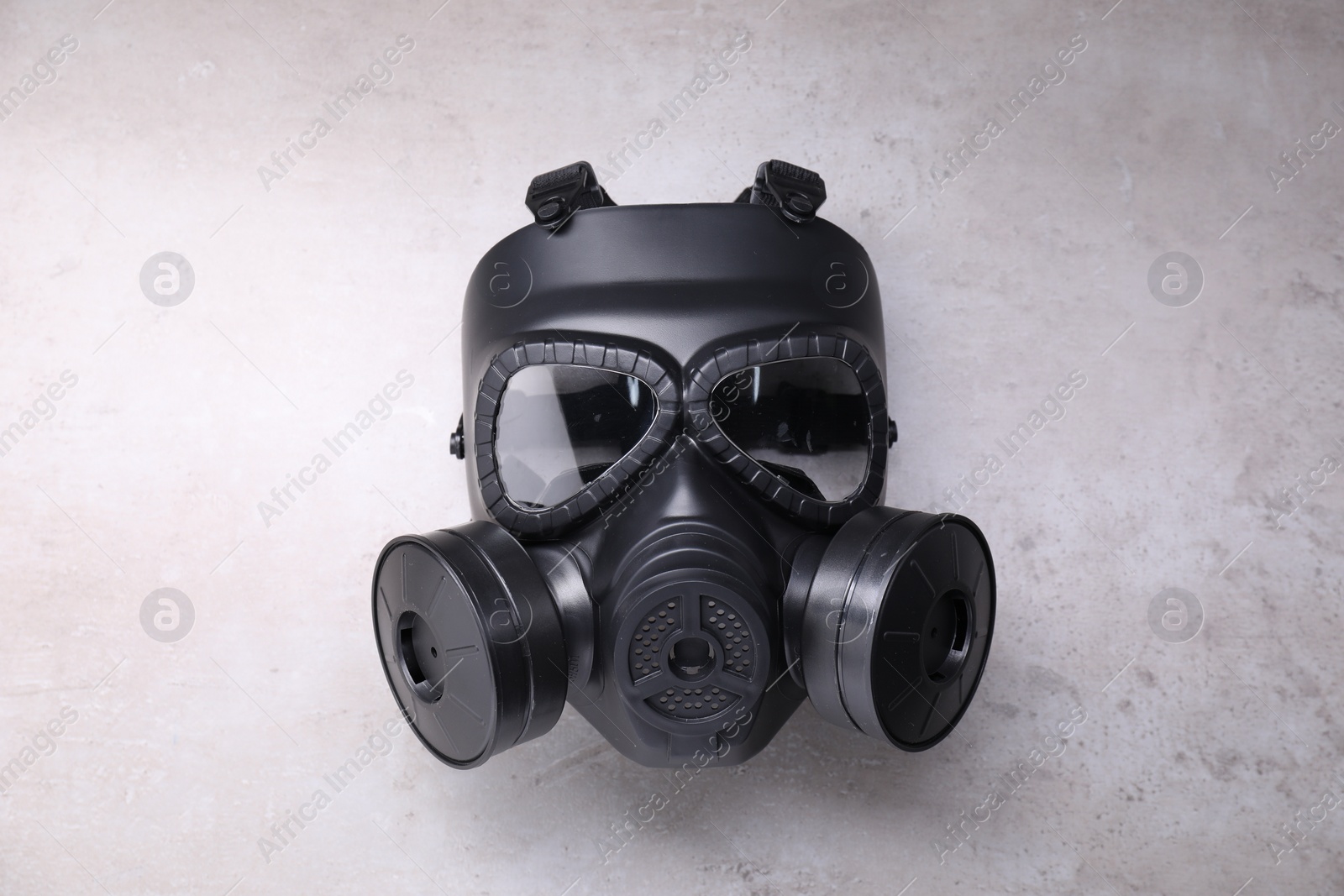 Photo of One gas mask on grey textured background, top view