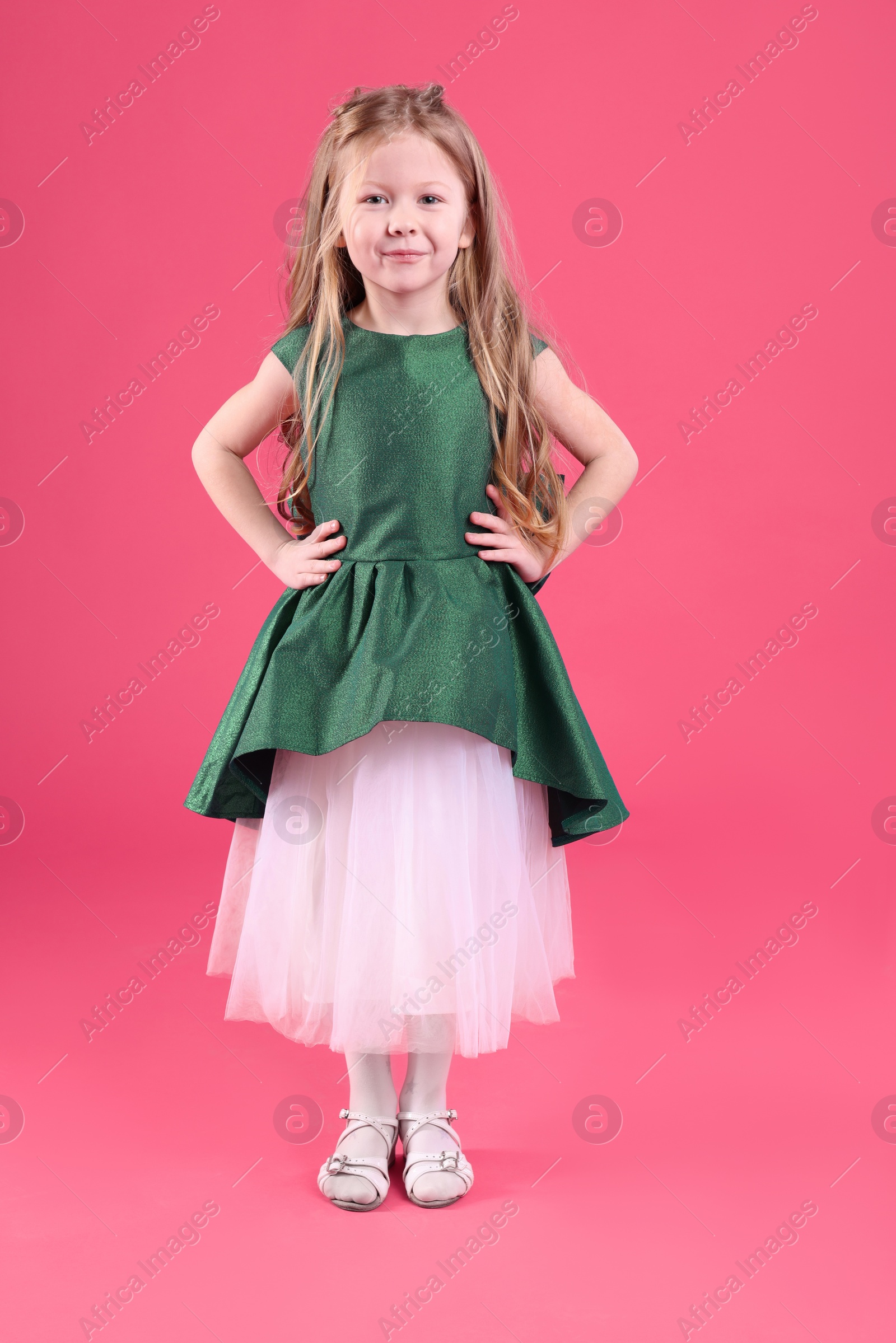 Photo of Cute girl in beautiful dress on pink background. Little princess