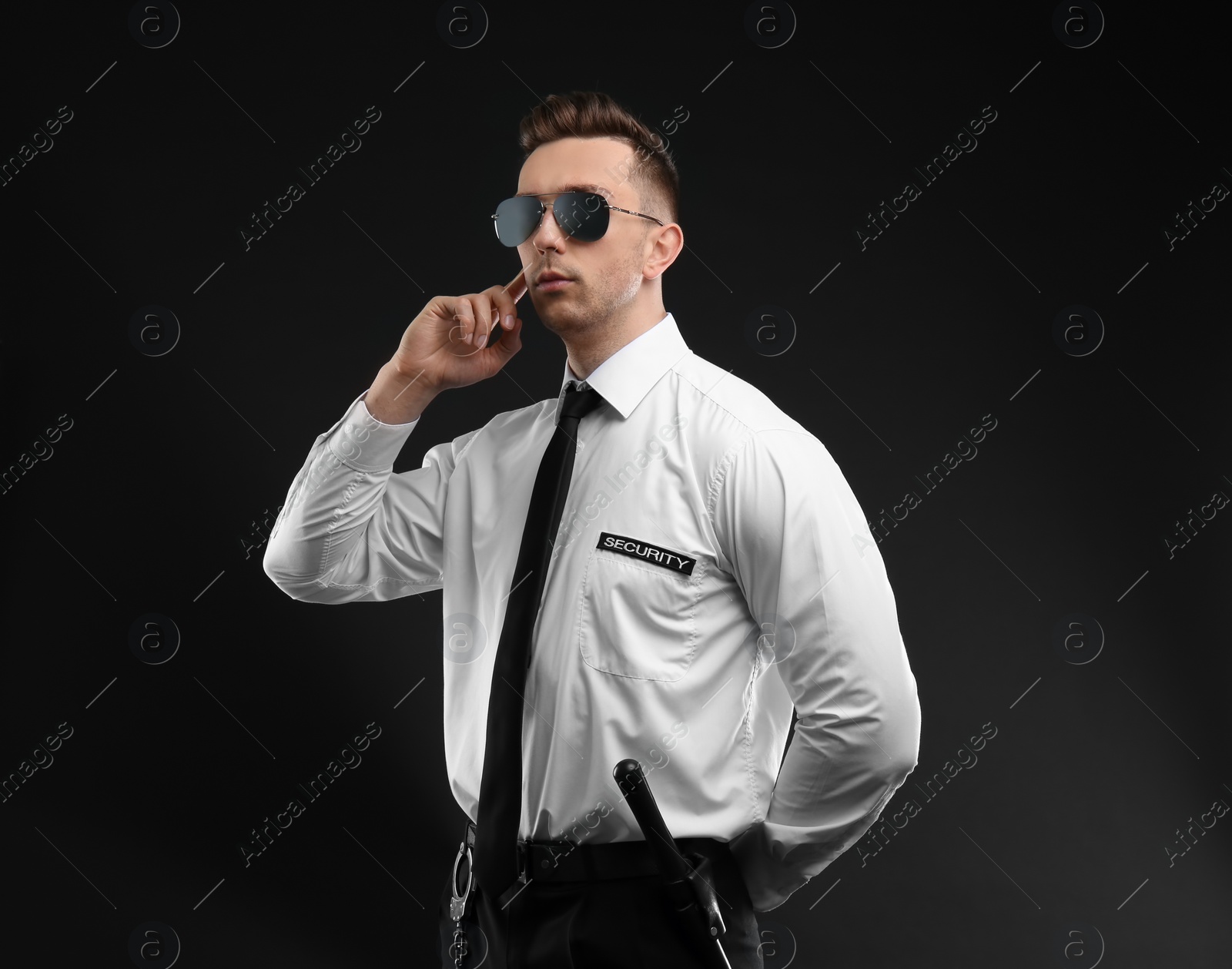 Photo of Male security guard in uniform on dark background