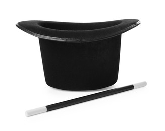 Photo of Black top hat and wand isolated on white. Magician equipment