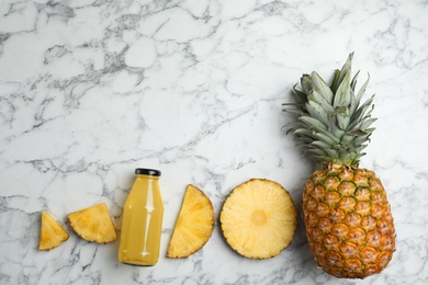 Delicious pineapple juice and fresh fruit on white marble table, flat lay