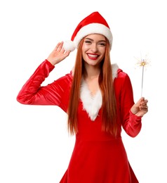 Photo of Young woman in red dress and Santa hat with burning sparkler on white background. Christmas celebration