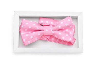 Photo of Stylish pink bow tie with polka dot pattern on white background, top view