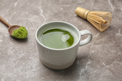 Cup of fresh matcha tea on table