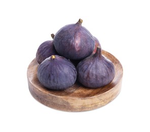 Wooden plate with whole fresh purple figs isolated on white