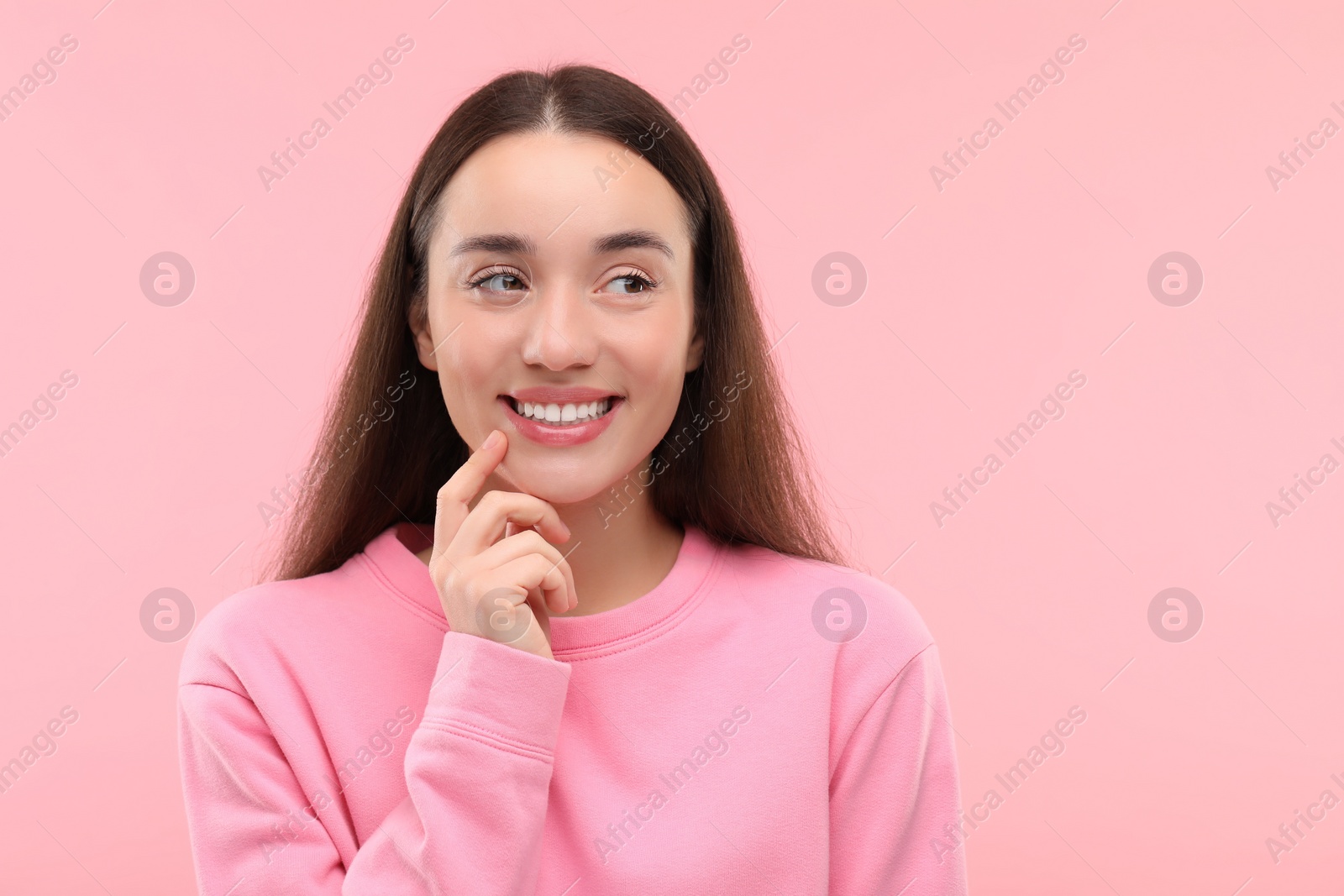 Photo of Beautiful woman with clean teeth smiling on pink background, space for text