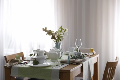 Photo of Beautiful Easter table setting with festive decor indoors