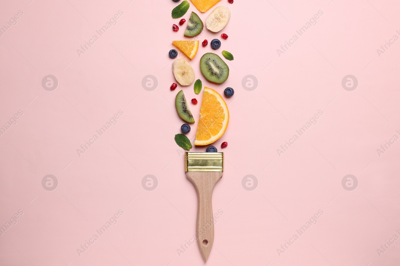 Photo of Creative flat lay composition with paint brush, fruits and berries on beige background