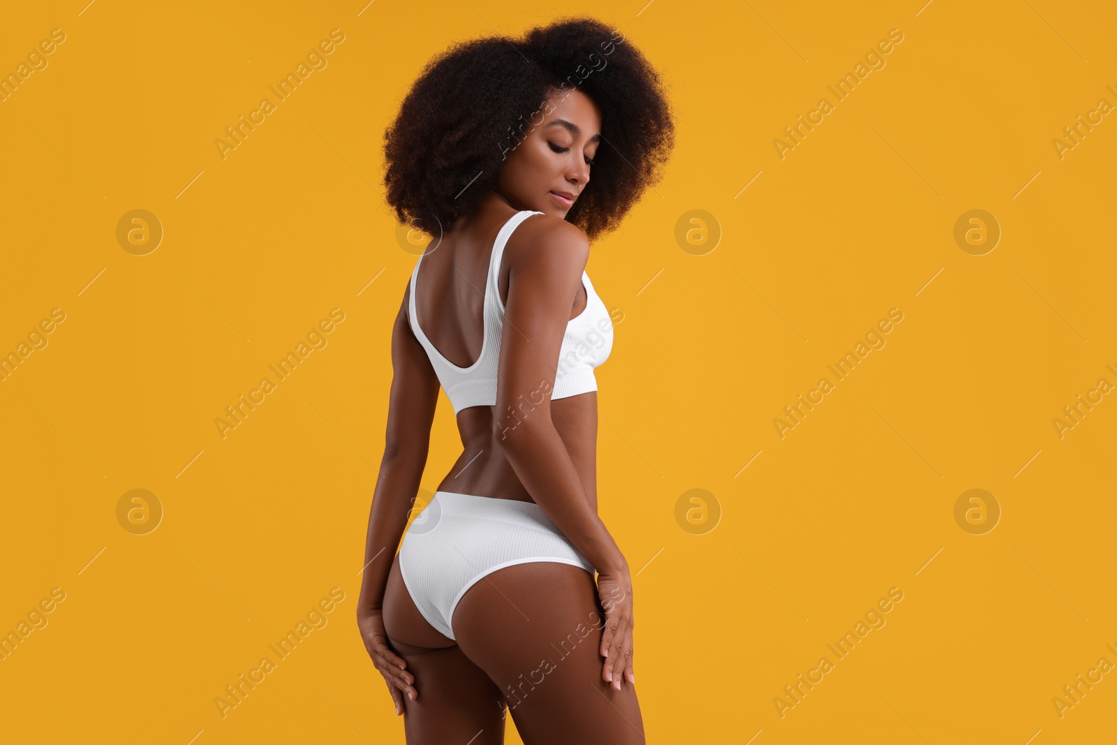 Photo of Beautiful woman in stylish bikini on yellow background