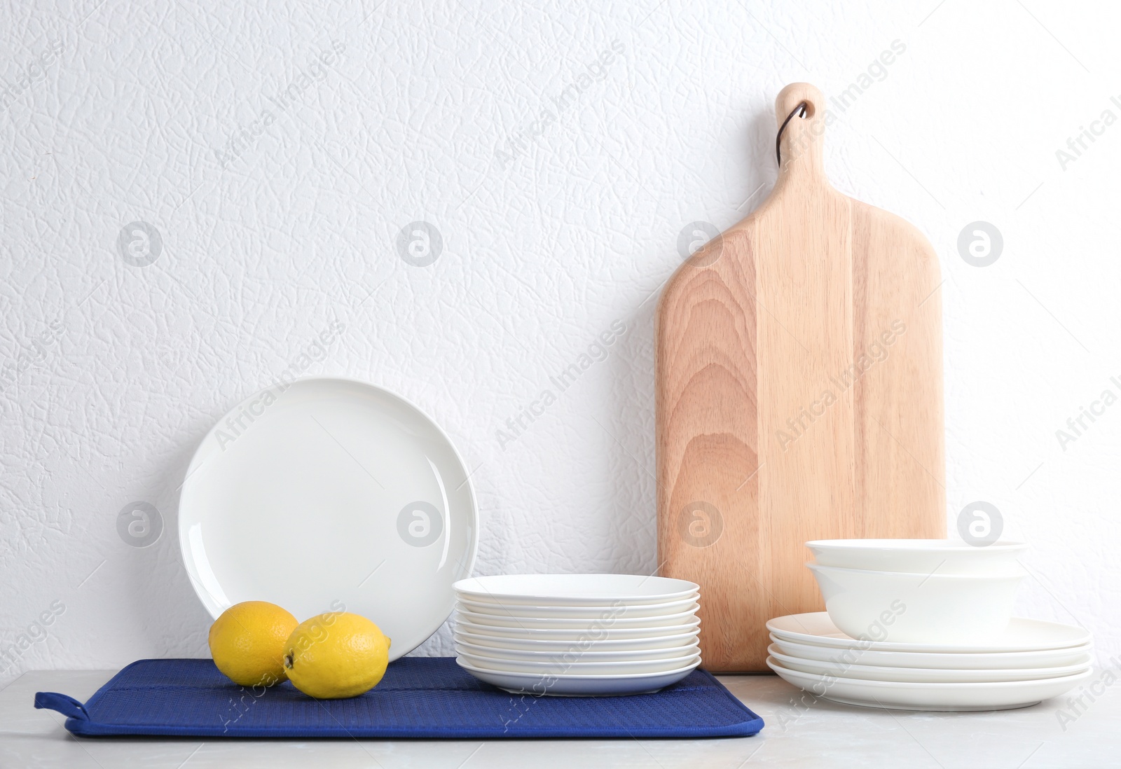 Photo of Set of dishware on table against white background