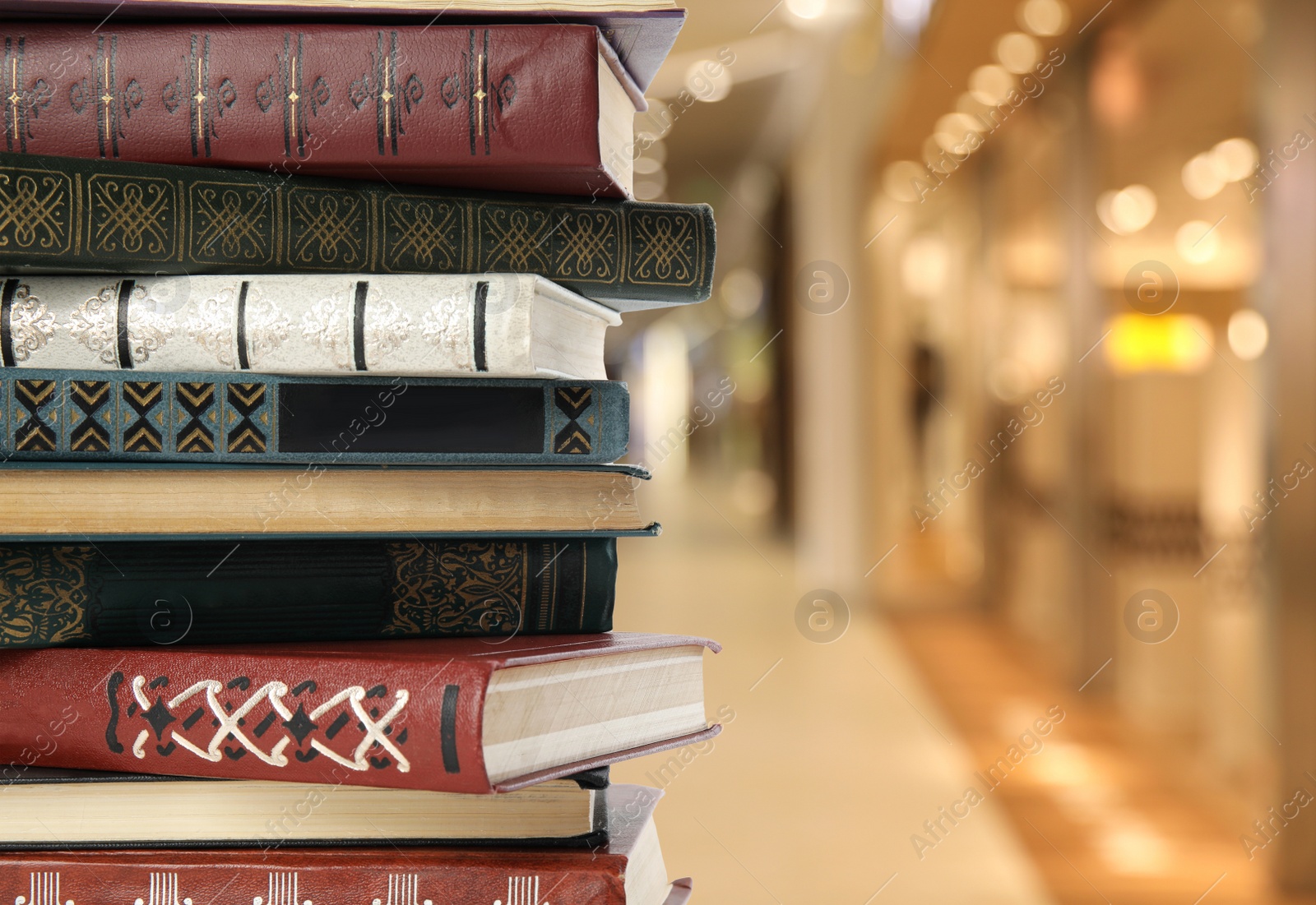 Image of Collection of different books against blurred background, space for text