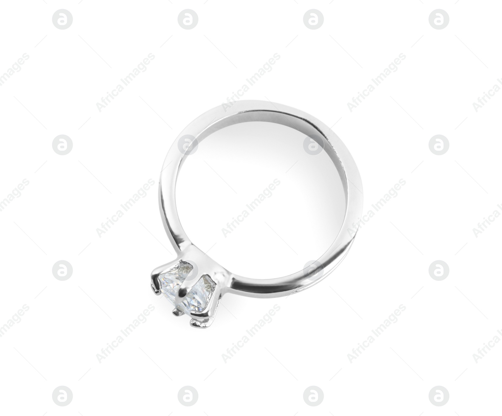 Photo of Beautiful engagement ring with gemstone isolated on white, top view