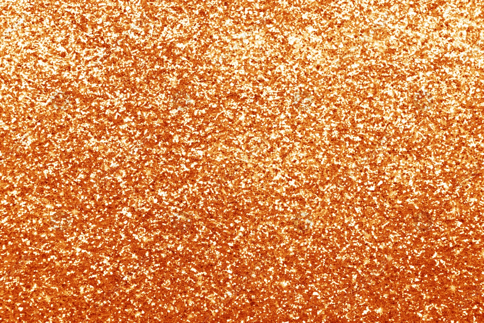 Image of Beautiful shiny orange glitter as background, closeup