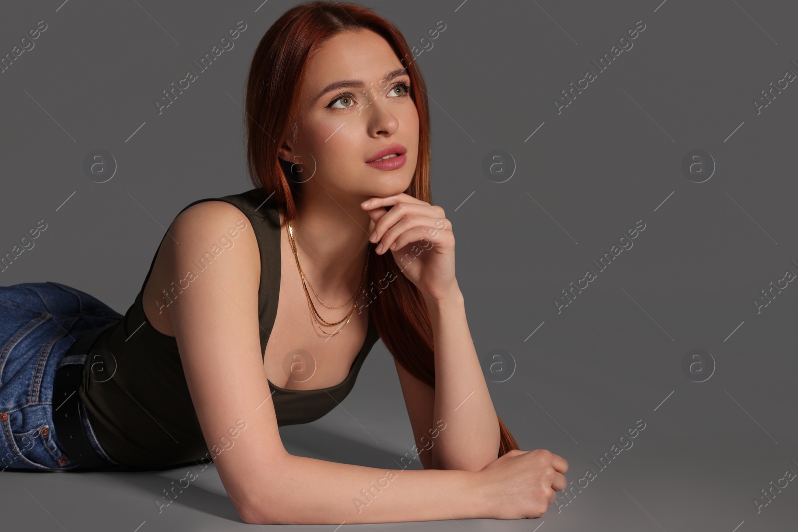 Photo of Beautiful young woman on gray background, space for text