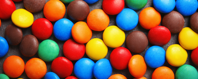 Many colorful candies as background, top view. Banner design 