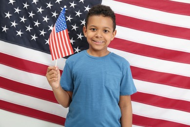 Photo of Happy African American boy with national flags
