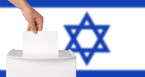Image of Man putting his vote into ballot box against national flag of Israel, closeup. Banner design with space for text