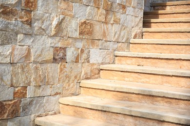 Photo of View of beautiful stone stairs near brick wall outdoors