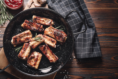 Image of Delicious grilled ribs served on wooden table, flat lay. Food photography  