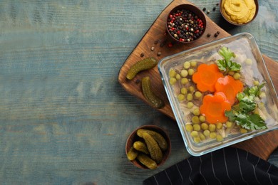 Delicious aspic and ingredients served on light blue wooden table, flat lay. Space for text