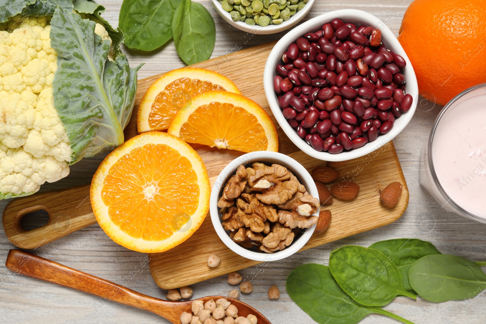 Photo of Set of natural food high in calcium on white wooden table, flat lay