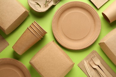 Photo of Flat lay composition with eco friendly products on light green background